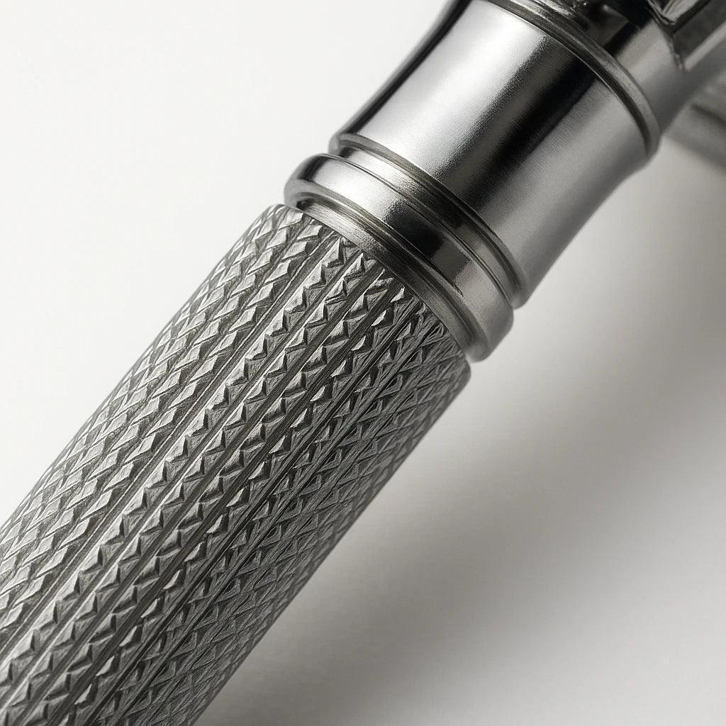 Close-up of a metallic handle with textured grip and shiny metallic finish on a light gray background